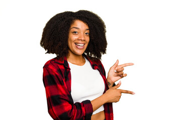 Young African American woman isolated excited pointing with forefingers away.