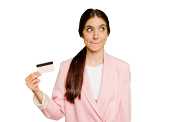 Business caucasian woman holding a credit card isolated confused, feels doubtful and unsure.