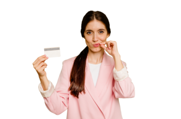 Business caucasian woman holding a credit card isolated with fingers on lips keeping a secret.