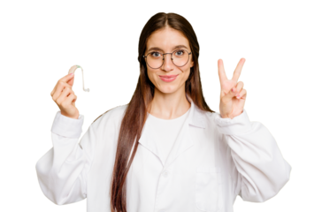 Young otorhinolaryngologist caucasian woman holding hearing aid isolated showing number two with fingers.