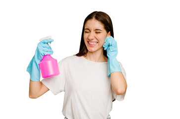 Young cleaner woman isolated covering ears with hands.