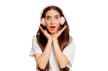 Young caucasian woman wearing headphones isolated surprised and shocked.