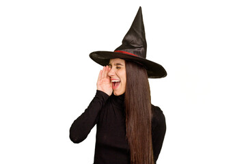 Young caucasian woman dressed as a witch for halloween day isolated shouting and holding palm near opened mouth.