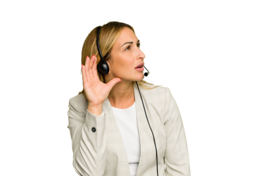 Telemarketer caucasian woman working with a headset isolated on green chroma background trying to listening a gossip.