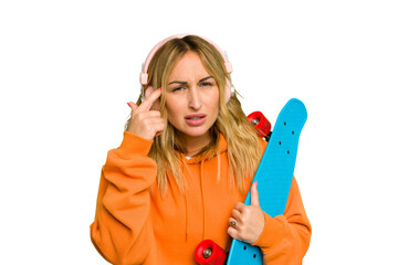 Young caucasian skater woman isolated on green chroma background showing a disappointment gesture with forefinger.