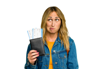 Young caucasian woman holding a passport isolated on green chroma background confused, feels doubtful and unsure.