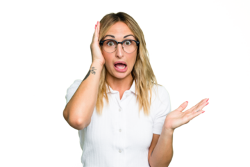 Young caucasian woman isolated on green chroma background impressed holding copy space on palm.