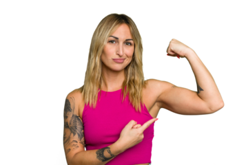 Young caucasian woman isolated on green chroma background showing strength gesture with arms, symbol of feminine power