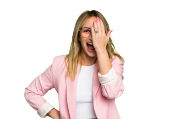 Young caucasian woman isolated on green chroma background having fun covering half of face with palm.