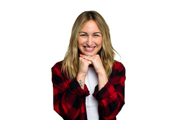 Young caucasian woman isolated on green chroma background keeps hands under chin, is looking happily aside.