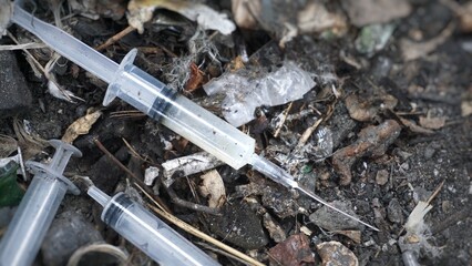 Used syringes, discarded,  Syringes lie in an abandoned house, at a construction site, in ruins, in the garbage, drug addicts left the drug