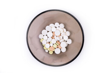 Medical pills on a white background in a plate