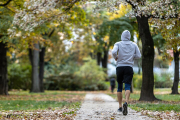 Obraz premium Man running alone in Budapest park in the afternoon, Hungary.