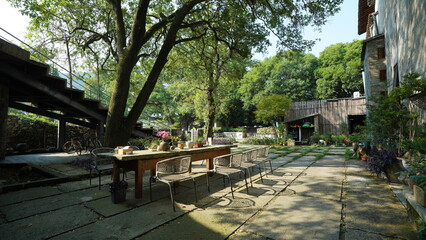 The beautiful garden view with the flowers and stone tables in the countryside village of the China