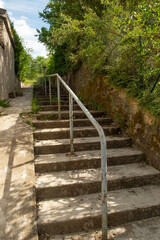escalier extérieur en béton, avec une rampe métallique et une pente douce pour les cycles et les...