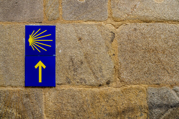 Camino de Santiago sign on stone facade in the city of Pontevedra, in Galicia, Spain.