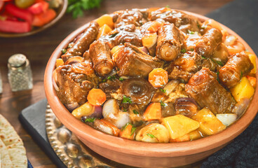 Arabic Cuisine; Egyptian traditional oxtails stew with vegetables. Served with traditional flatbread and pickles.