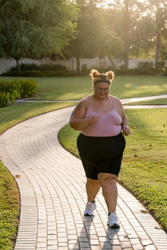 Plus Sized Woman Walking Outdoors Doing Exercise