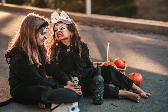 two little girls dressed as black cats celebrating a Halloween party