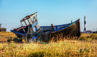 Fototapeta na wymiar Abandoned Boat Wreck on the Beach at the Dungeness Headland, Kent, England