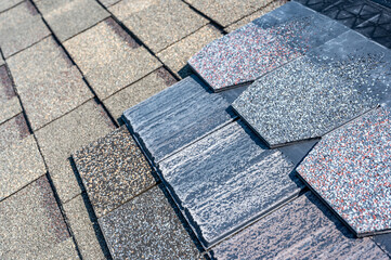 Assorted selection of premium synthetic roof shingles to pick a new style. © Lost_in_the_Midwest