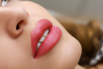 beautiful permanent makeup stupidly executed with soft red pigment, the model opened her lips - obrazy, fototapety, plakaty
