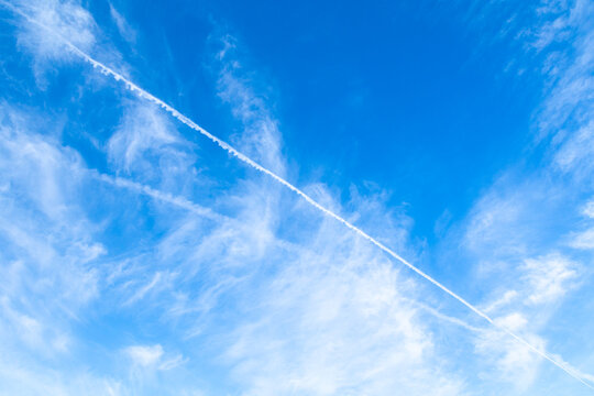 Background or wallpaper blue sky with clouds, photo taken in sunny day, flight trail, chemtrails
