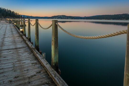 Scenic view of a wooden dock with a beautiful sunset in the background in Coeur d'Alene