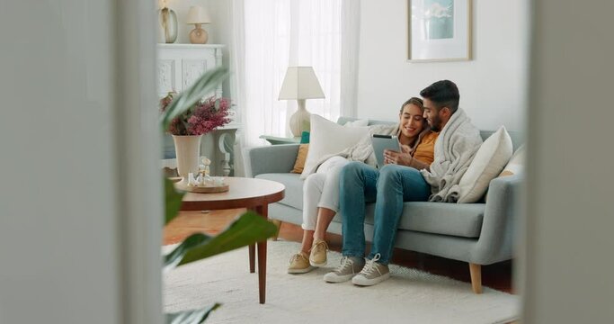 Smile, internet and couple streaming on a tablet from the living room sofa of their house. Happy, relax and calm man and woman with an online movie, social media or comic video on the internet