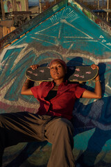 Portrait of young non-binary with skateboard in skatepark  © Sheilby Macena