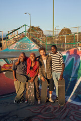 Portrait of four young skateboarders at the skatepark 

