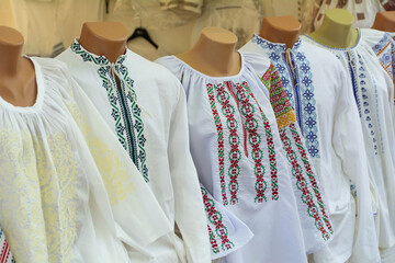 Moldovan embroideries. Men's and women's Moldovan embroidered shirts at the fair. Balkan...
