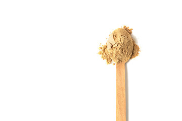 Top view of a spoon with raw maca root powder isolated on white