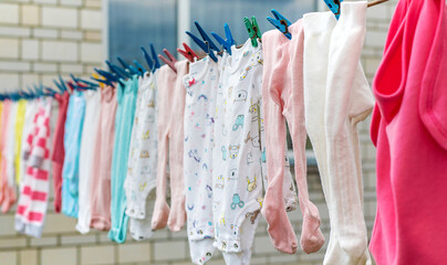 Children clothes dry outside after washing. Selective focus.