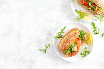 Sandwiches with salted salmon, arugula and cucumber. Breakfast. Top view