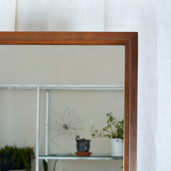 Vintage mid-century modern walnut mirror. Interior room with minimal design furniture, white...