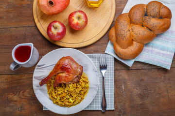 Spelled with duck leg in a plate on the festive table for Rosh Hashanah.