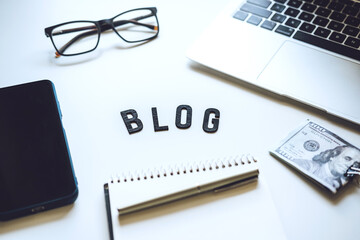 How To Start Blog, Blogging for Beginners. Ways to monetize your blog. Blog word on table with laptop, smartphone, open notebook, dollar banknotes and glasses