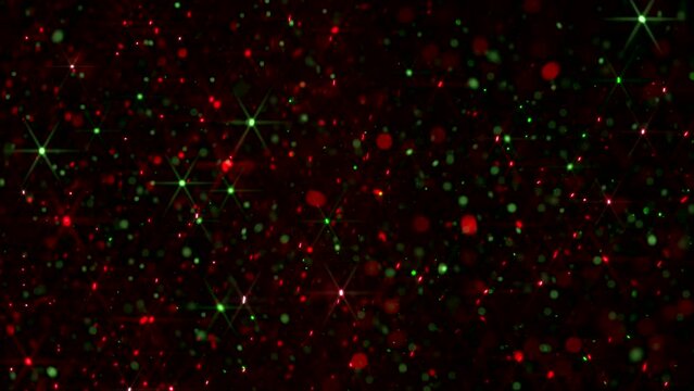 A Composite Video Of Various Sized Floating Red And Green Particles Against A Black Background With Added Light Glint Effect In A Seamless Loop Animation. Christmas Background Overlay.
