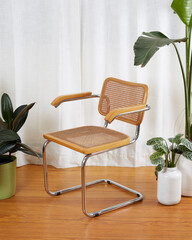 Mid-century modern wooden chrome and cane Cantilever chair detail. Interior product photograph with...