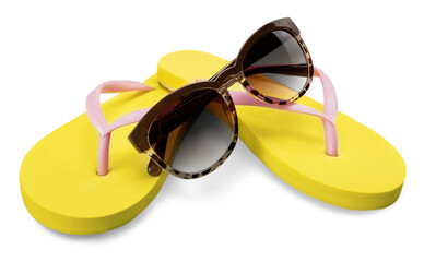 Yellow flip flops and sunglasses on white