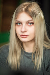 Fototapeta premium Portrait of a young beautiful fair-haired girl with a dress.