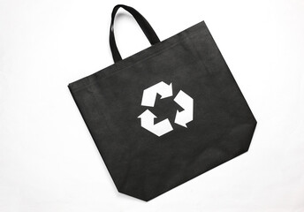 Black shopping bag with circular recycling symbol isolated on white background. Eco concept