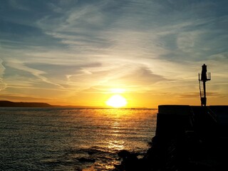 Sunrise over Looe Beach and Banjo Pier.