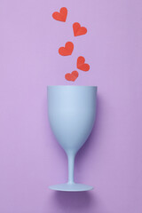 Plastic glass with hearts on a pastel background on a pastel background. Romantic, Love concept