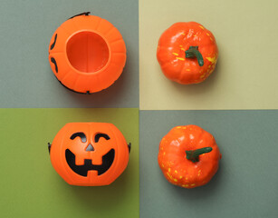 Halloween buckets and plastic decorative pumpkins on a four tone green background. Trick or treat. Top view