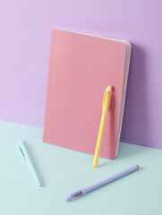 Modern and creative composition with pens on a two tone pastel background. Minimal still life. Fresh idea. Business, education concept