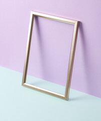Creative layout with golden frame on pastel background. Conceptual pop. Minimal still life