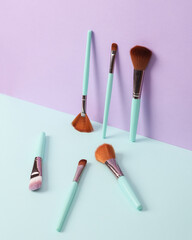Creative beauty layout with makeup brushes on pastel background. Conceptual pop. Minimal fashion still life