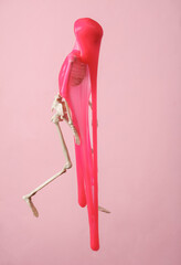 Skeleton with slime on pink background. Fresh idea. Minimalism halloween concept